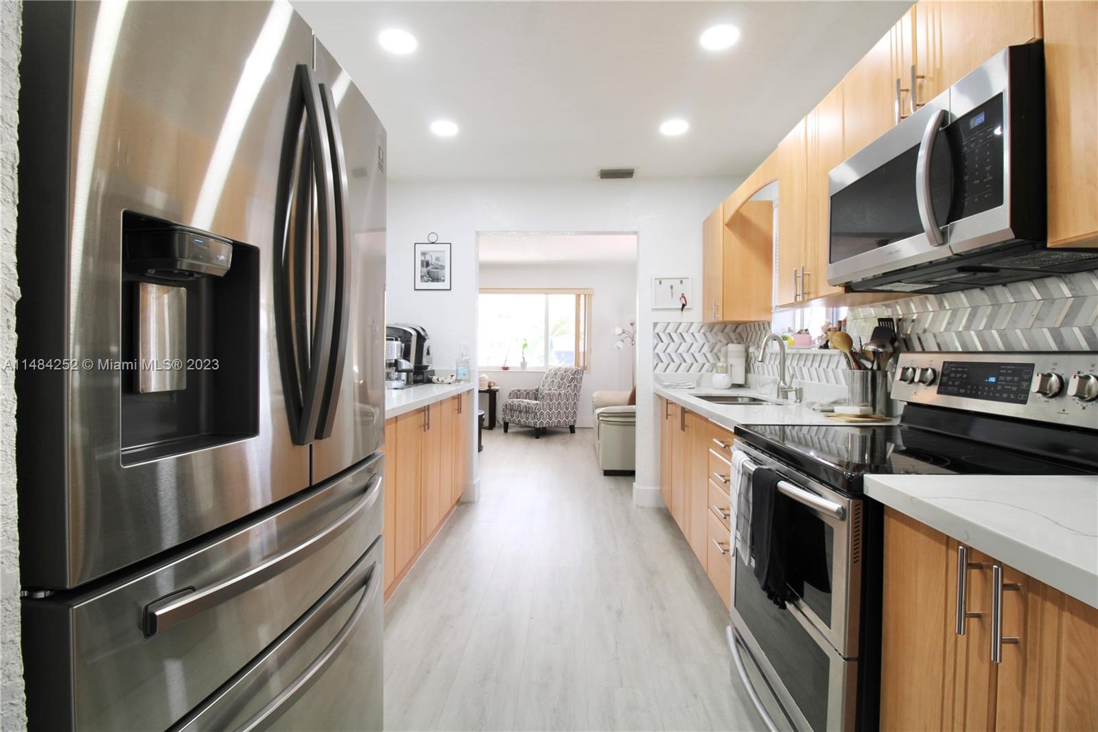 1085 West 23rd Street Hialeah, FL 33010 - Photo 8 of 32 a large kitchen with stainless steel appliances