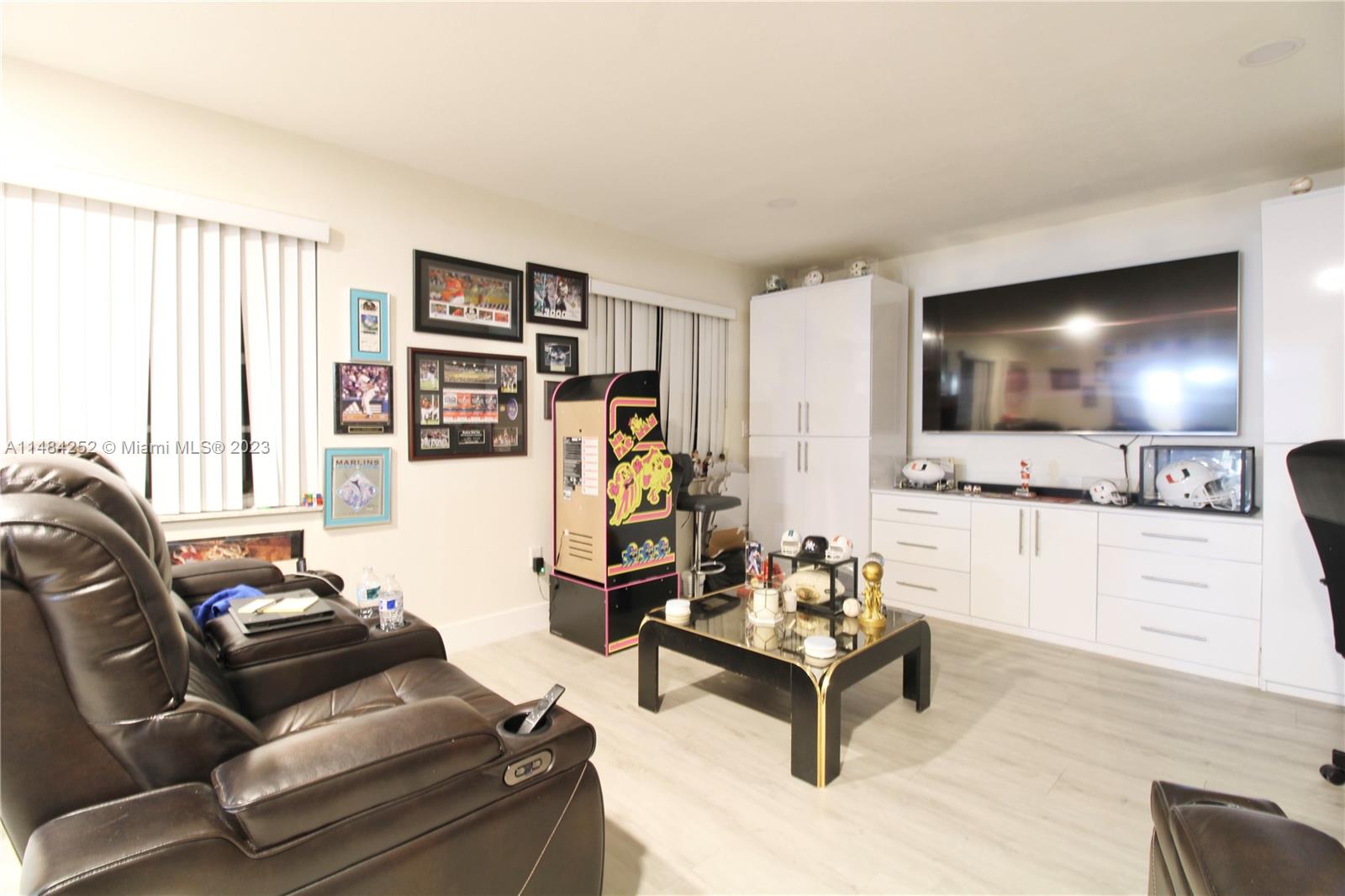 1085 West 23rd Street Hialeah, FL 33010 - Photo 10 of 32 a living room with furniture and a flat screen tv
