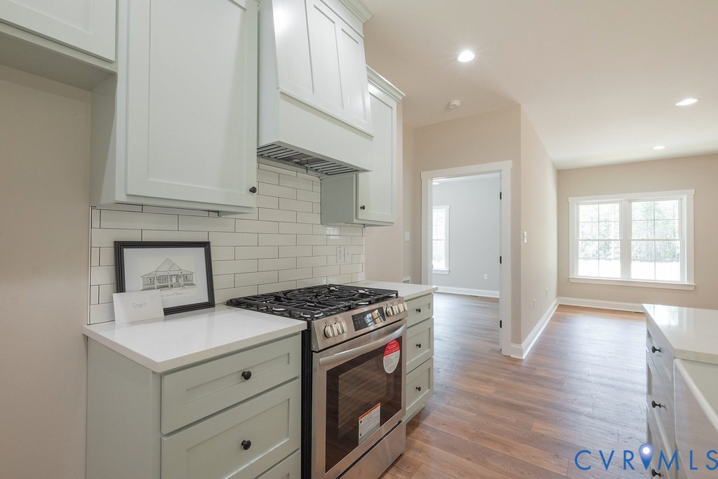 2223 Ridge Road Arvonia, VA 23004 - Photo 21 of 45 Kitchen featuring light-toned cabinetry, subway ti