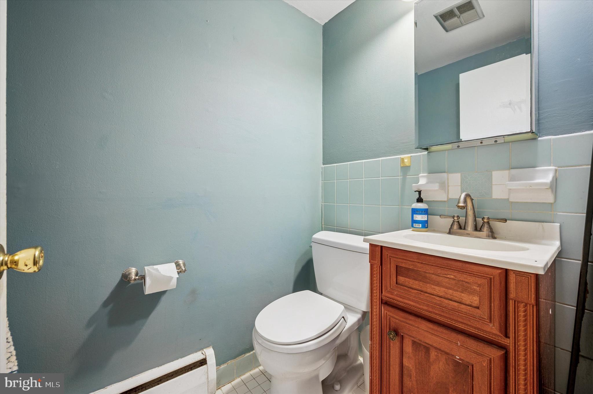 1600 Church Road, Unit A107 Wyncote, PA 19095 - Photo 15 of 15 a bathroom with a sink a toilet and a mirror