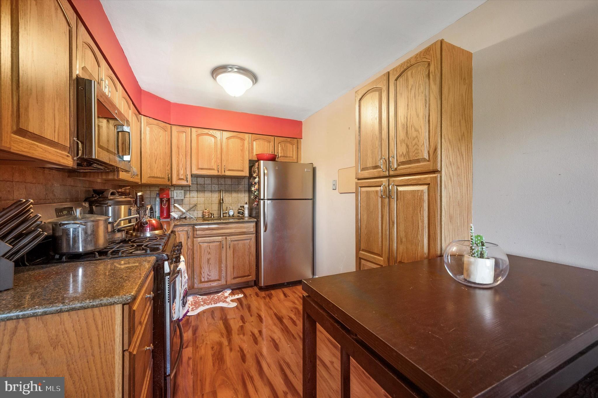 1600 Church Road, Unit A107 Wyncote, PA 19095 - Photo 4 of 15 a kitchen with stainless steel appliances a refrigerator and a stove top oven