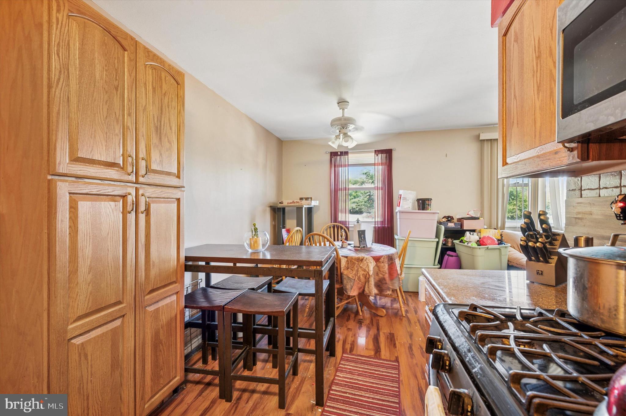 1600 Church Road, Unit A107 Wyncote, PA 19095 - Photo 6 of 15 a kitchen with stainless steel appliances granite countertop a stove and a refrigerator