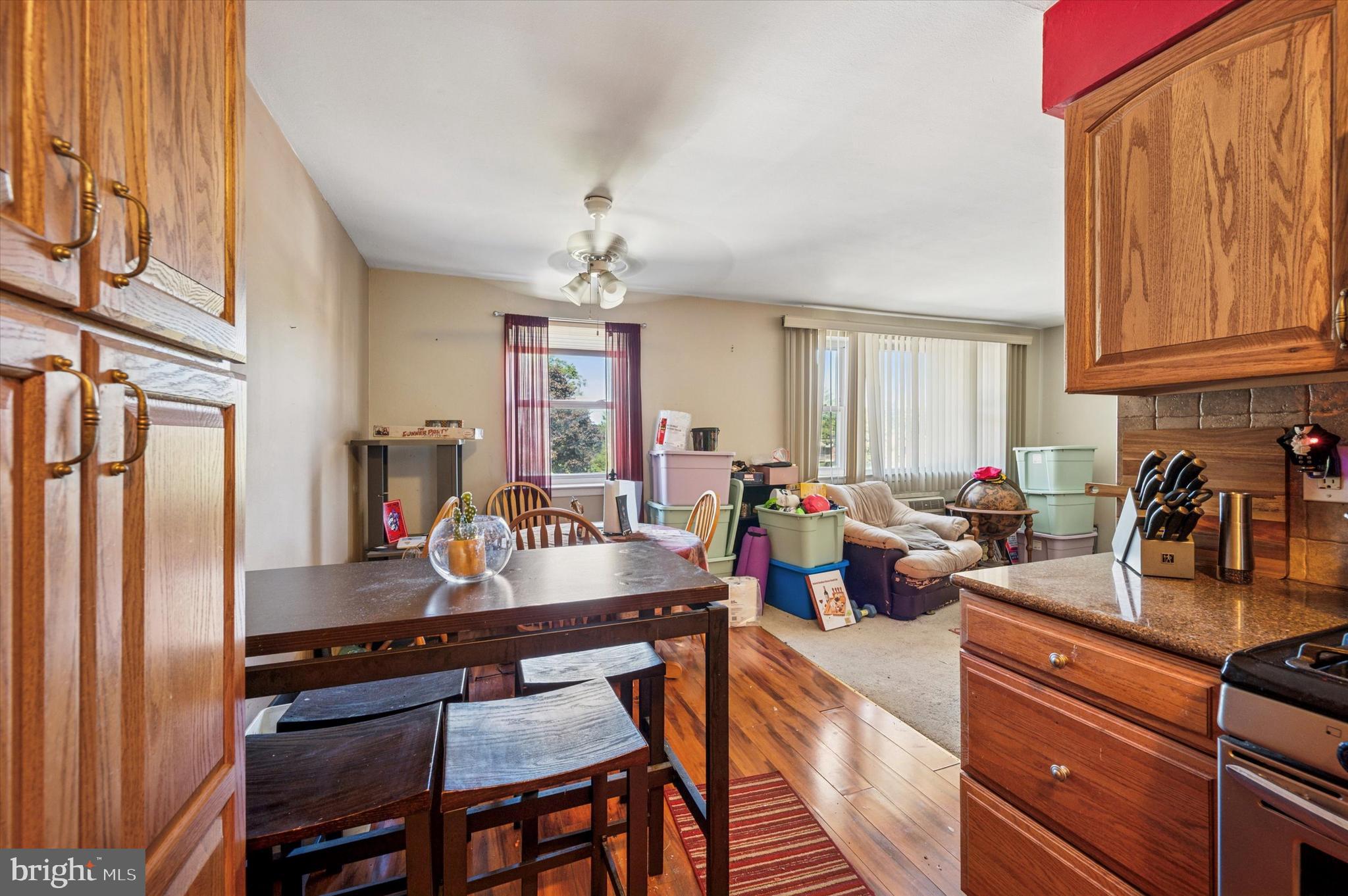 1600 Church Road, Unit A107 Wyncote, PA 19095 - Photo 7 of 15 a kitchen with sink refrigerator dining table and chairs