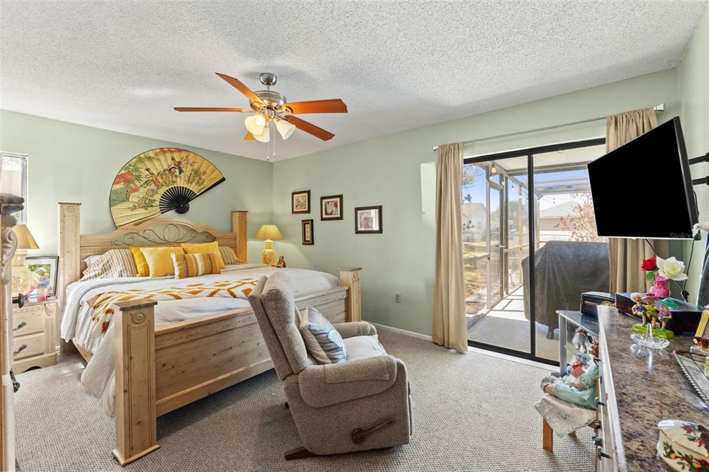 4151 Montano Avenue Spring Hill, FL 34609 - Photo 11 of 34 a bedroom with furniture and a flat screen tv