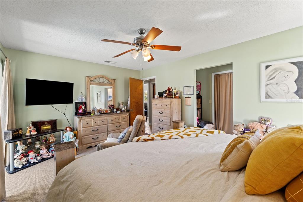 4151 Montano Avenue Spring Hill, FL 34609 - Photo 12 of 34 a bedroom with a bed and a flat tv screen on the dresser