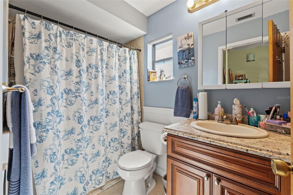 4151 Montano Avenue Spring Hill, FL 34609 - Photo 13 of 34 a bathroom with a sink toilet and shower