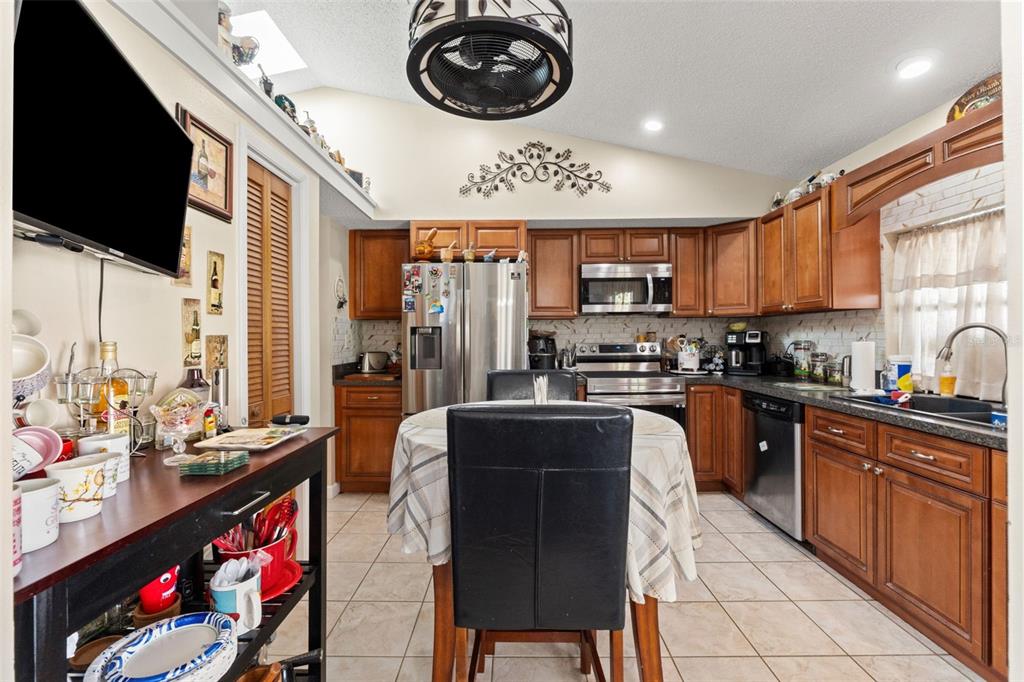 4151 Montano Avenue Spring Hill, FL 34609 - Photo 16 of 34 a kitchen with stainless steel appliances granite countertop a stove a sink and a microwave