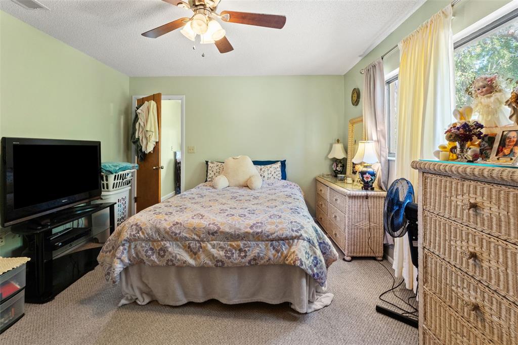 4151 Montano Avenue Spring Hill, FL 34609 - Photo 18 of 34 a bed room with a bed and a television