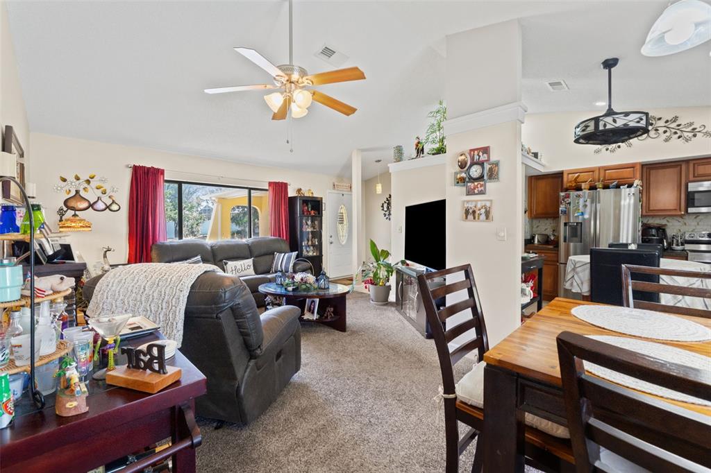4151 Montano Avenue Spring Hill, FL 34609 - Photo 21 of 34 a living room with furniture a flat screen tv and a window