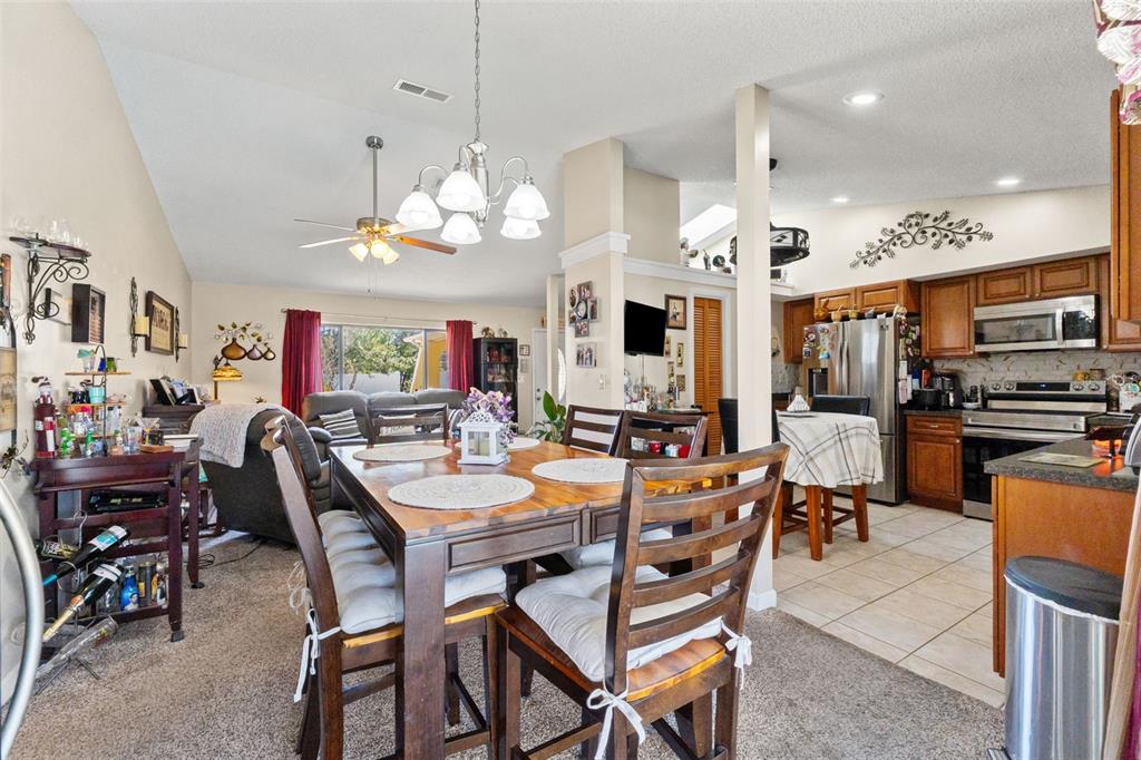 4151 Montano Avenue Spring Hill, FL 34609 - Photo 23 of 34 a view of a dining area with furniture and a kitchen