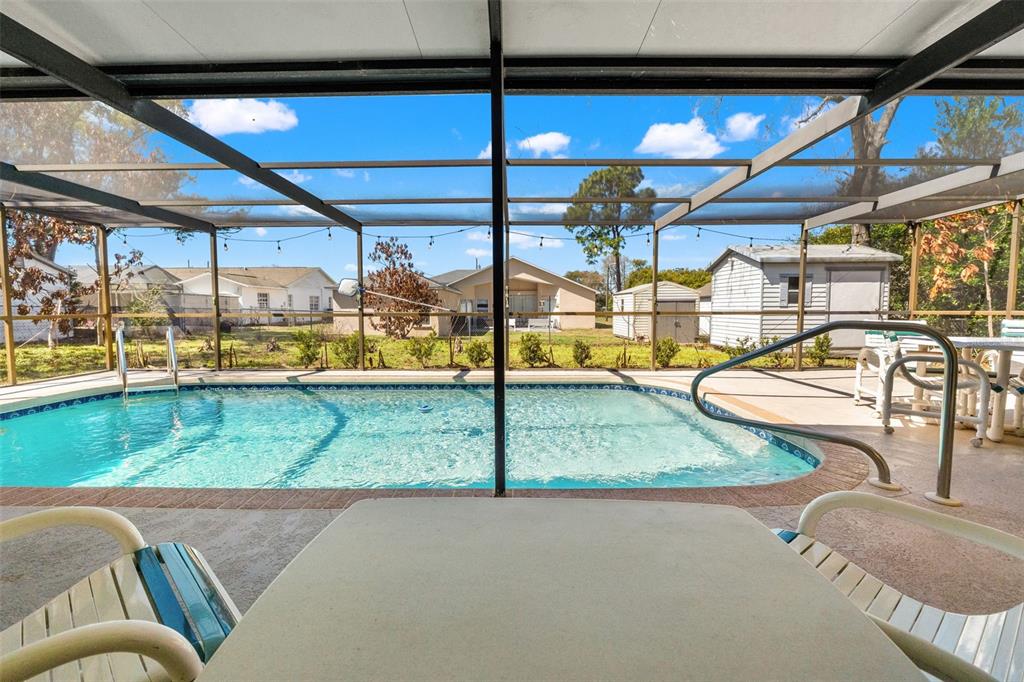 4151 Montano Avenue Spring Hill, FL 34609 - Photo 27 of 34 a view of a swimming pool with a patio