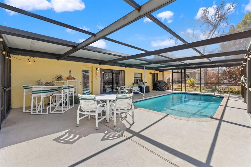 4151 Montano Avenue Spring Hill, FL 34609 - Photo 28 of 34 a table and chairs in a patio