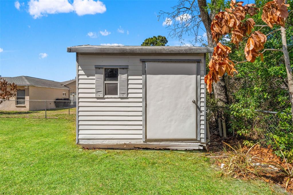 4151 Montano Avenue Spring Hill, FL 34609 - Photo 34 of 34 a front view of a house with a yard