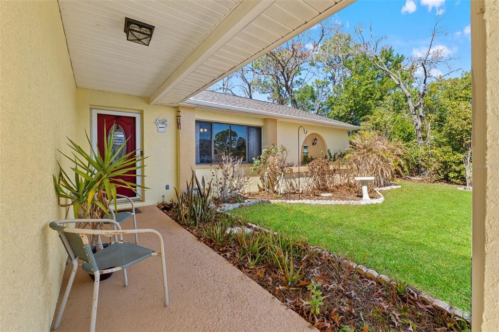 4151 Montano Avenue Spring Hill, FL 34609 - Photo 5 of 34 a view of a chair and table in backyard of the house