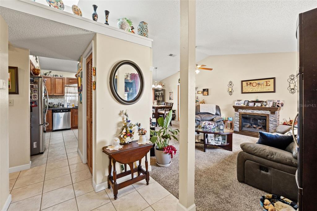 4151 Montano Avenue Spring Hill, FL 34609 - Photo 9 of 34 a living room with furniture a rug and a clock