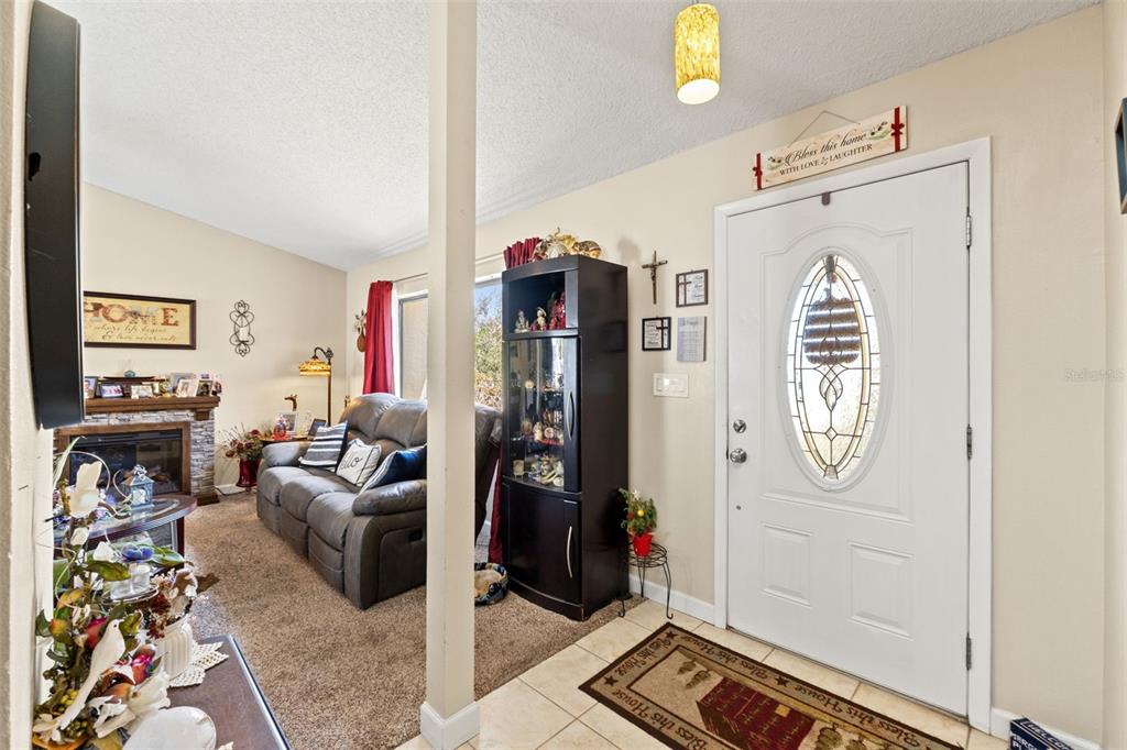 4151 Montano Avenue Spring Hill, FL 34609 - Photo 10 of 34 a living room with furniture and a chandelier