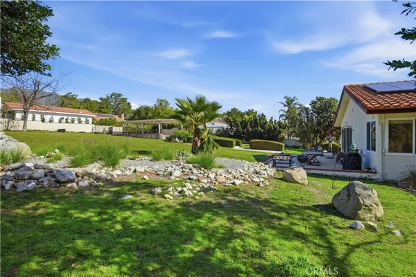 a view of a house with swimming pool and a yard