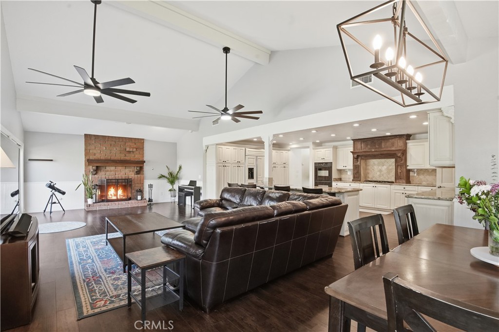 10902 Wilson Avenue Rancho Cucamonga, CA 91737 - Photo 14 of 48 a view of a dining room and livingroom with furniture wooden floor a chandelier