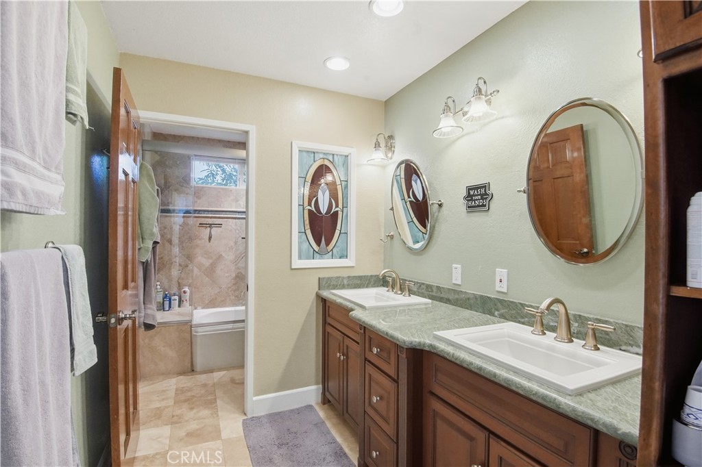 10902 Wilson Avenue Rancho Cucamonga, CA 91737 - Photo 24 of 48 a bathroom with a double vanity sink mirror and shower