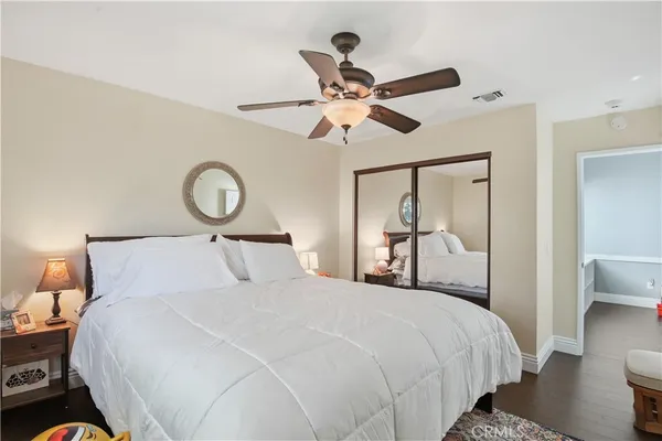 a bedroom with a large bed and a chandelier