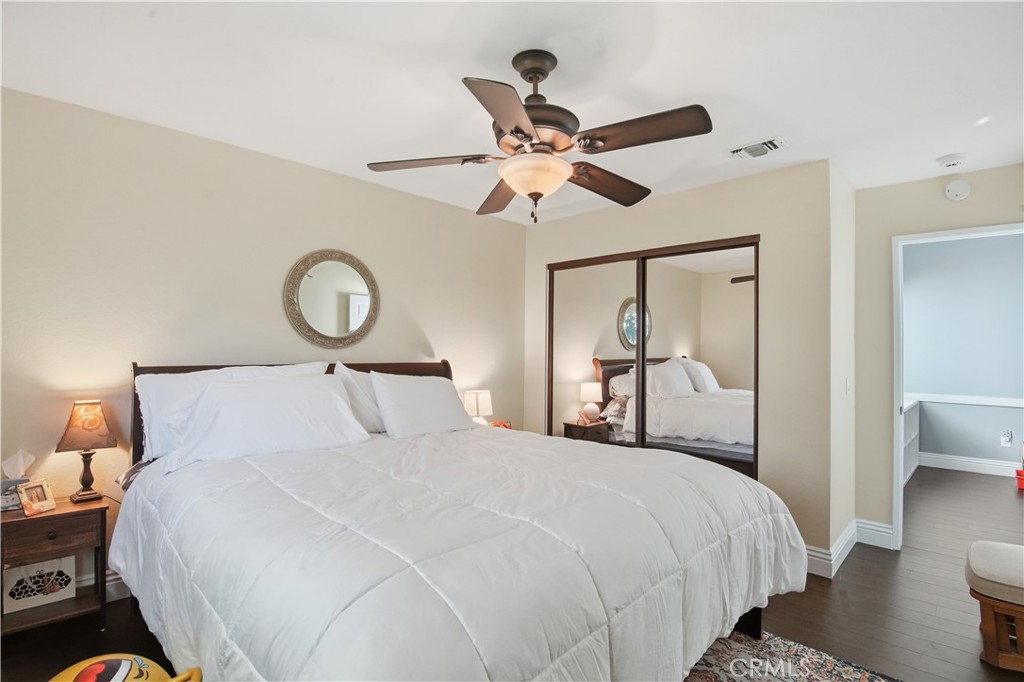10902 Wilson Avenue Rancho Cucamonga, CA 91737 - Photo 26 of 48 a bedroom with a large bed and a chandelier