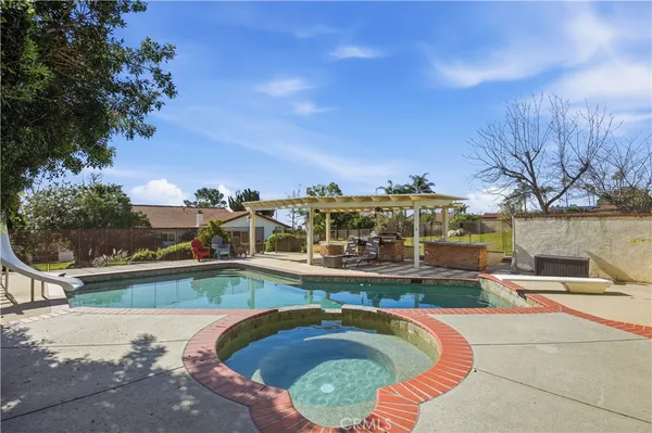 a swimming pool with outdoor seating and city view