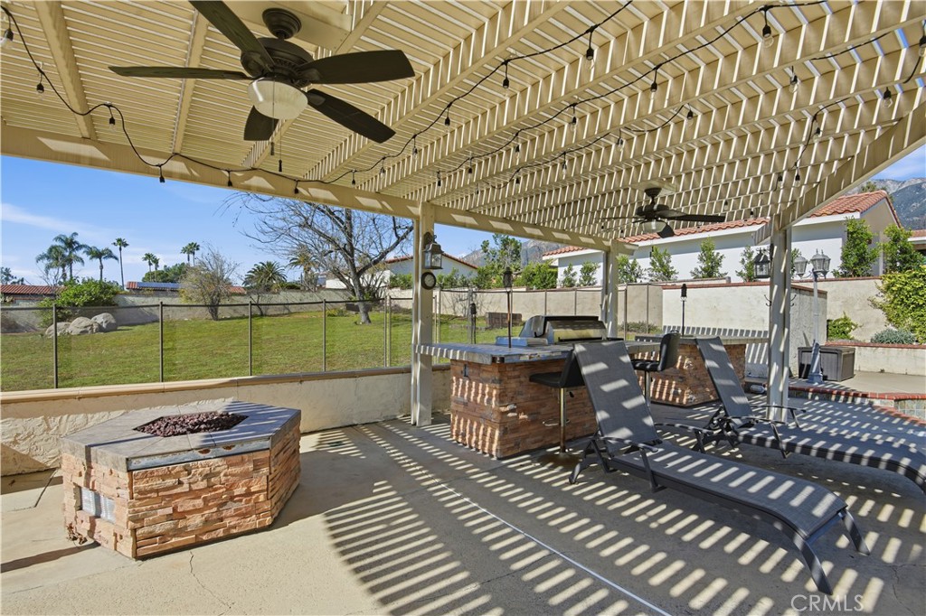 10902 Wilson Avenue Rancho Cucamonga, CA 91737 - Photo 36 of 48 a view of a patio with table and chairs with wooden floor