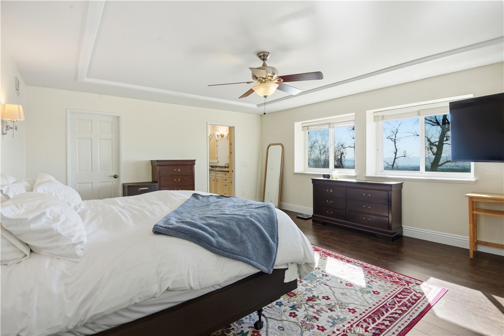 10902 Wilson Avenue Rancho Cucamonga, CA 91737 - Photo 37 of 48 a bedroom with a bed and a chandelier