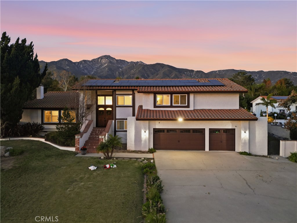 10902 Wilson Avenue Rancho Cucamonga, CA 91737 - Photo 43 of 48 a front view of a house with a yard and garage