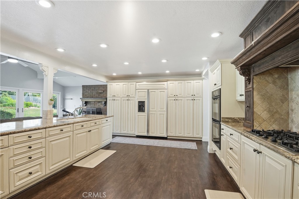 10902 Wilson Avenue Rancho Cucamonga, CA 91737 - Photo 10 of 48 a large kitchen with a lot of counter space and wooden floor