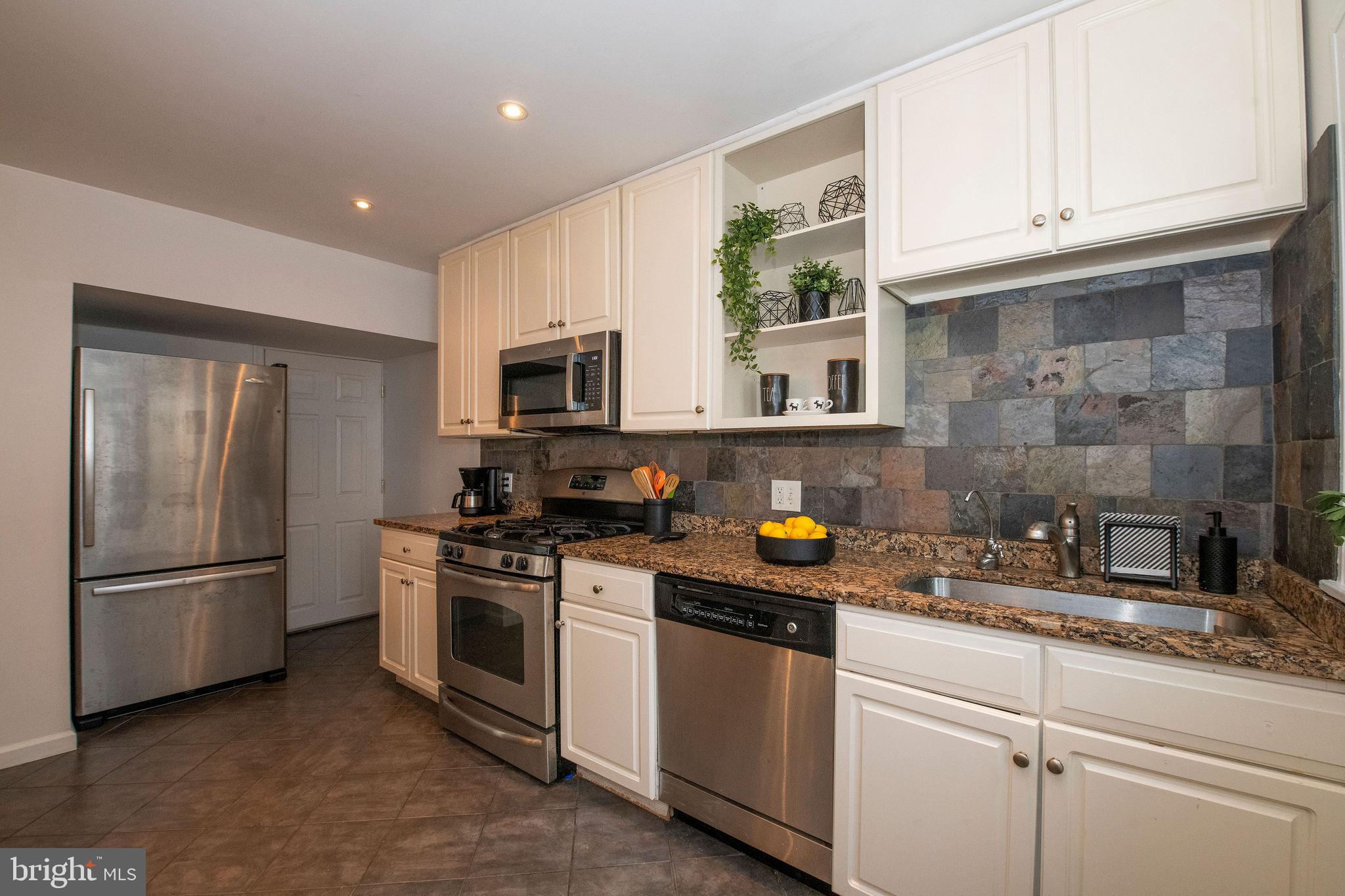 467 West Ellet Street Philadelphia, PA 19119 - Photo 14 of 39 a kitchen with a sink stainless steel appliances and cabinets