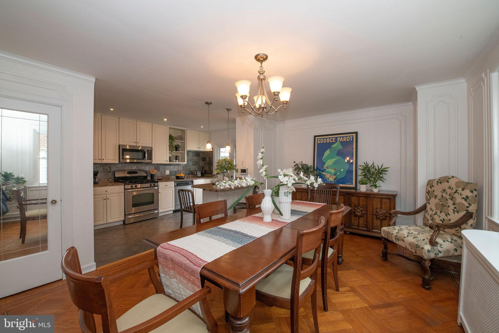 467 West Ellet Street Philadelphia, PA 19119 - Photo 10 of 39 a dining room with wooden floor a chandelier a glass table and chairs