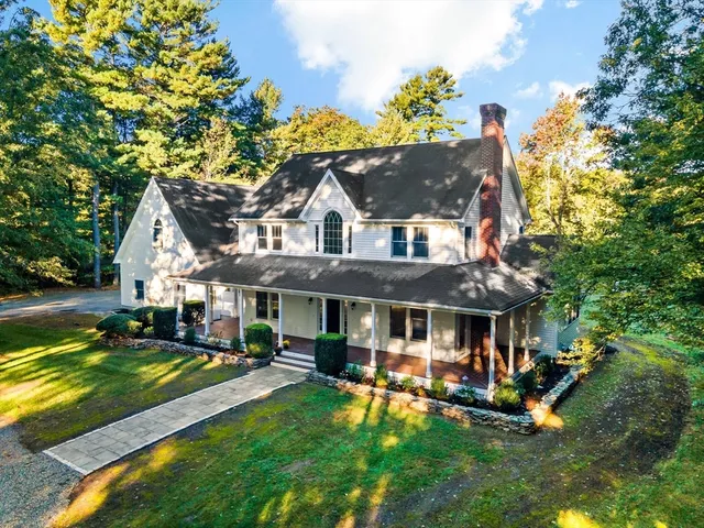 a view of a house with swimming pool and sitting area