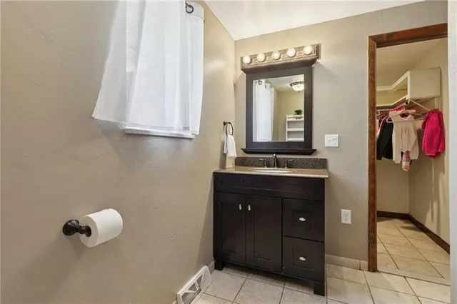 a bathroom with a sink vanity and mirror