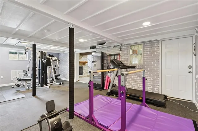 a view of a kitchen with kitchen island stainless steel appliances a sink and living room view