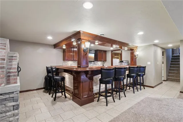 a kitchen with stainless steel appliances granite countertop a sink and a microwave