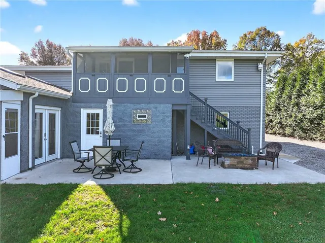 a view of a house with a yard and sitting area