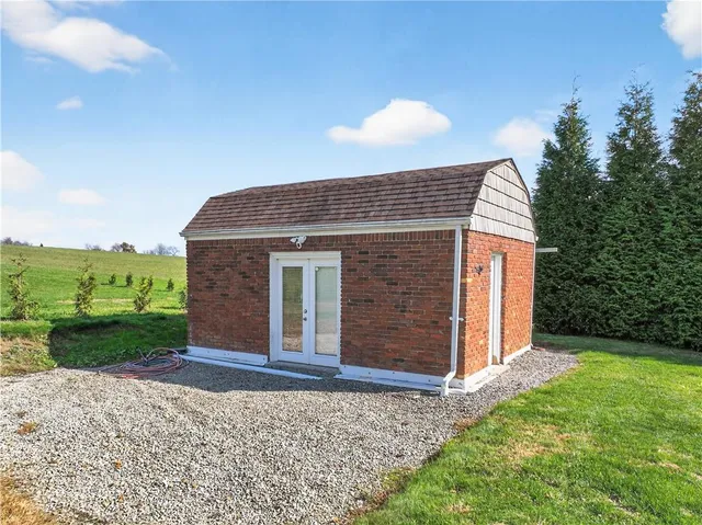 a view of a garden with swimming pool and sitting area