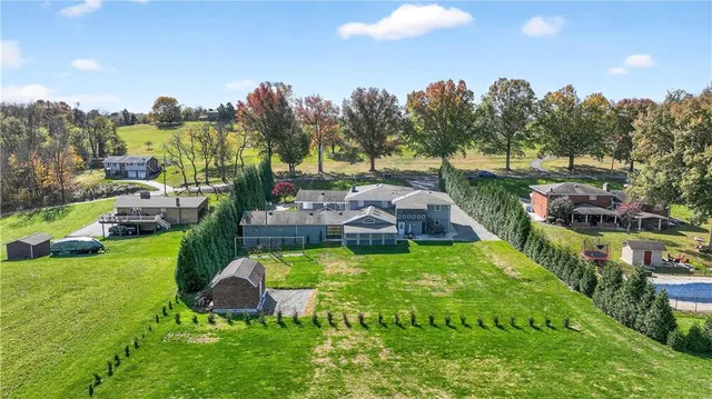 an aerial view of residential houses with outdoor space and swimming pool