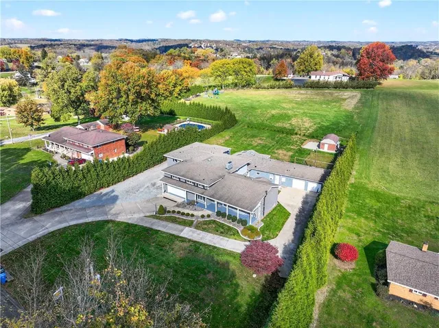 an aerial view of a houses with yard