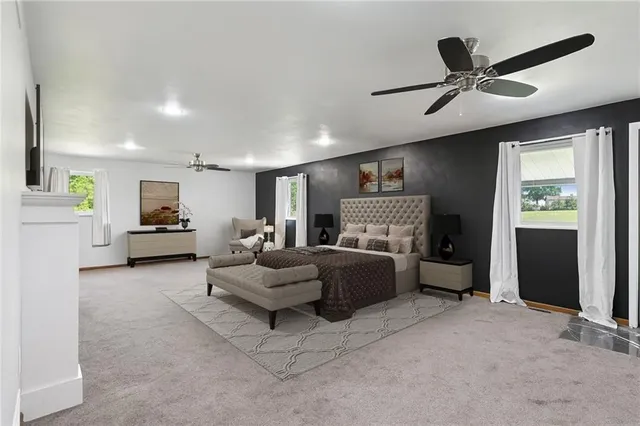 a living room with furniture and a ceiling fan