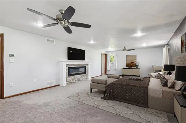 a bedroom with a bed furniture and a flat screen tv