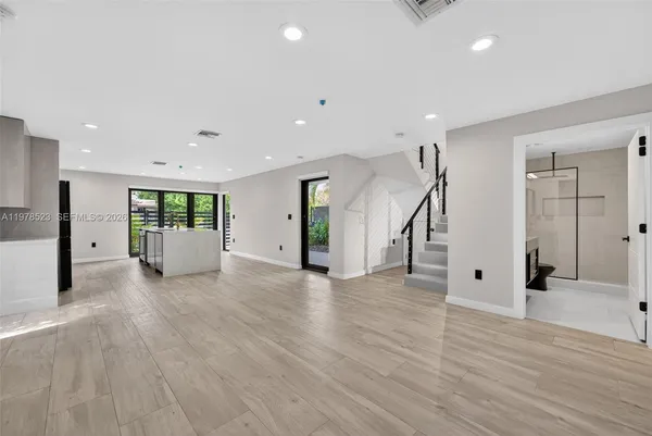 a view of an entryway with wooden floor