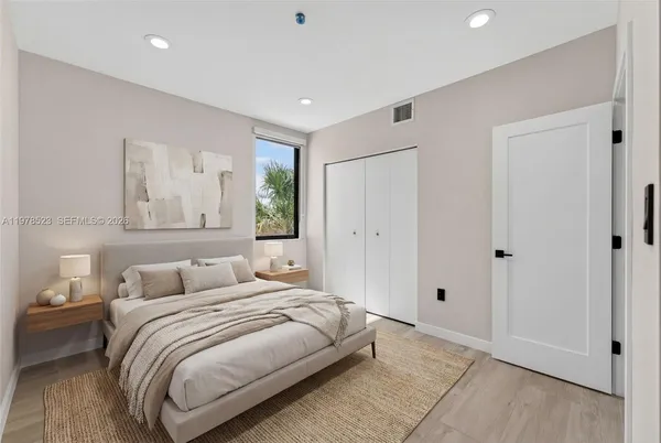 a bedroom with a large bed and a window