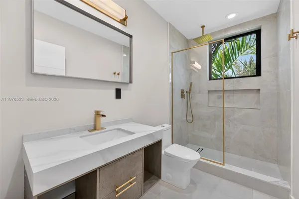 a bathroom with a sink toilet and shower