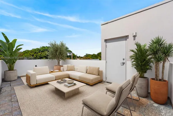 a living room with furniture and a potted plant