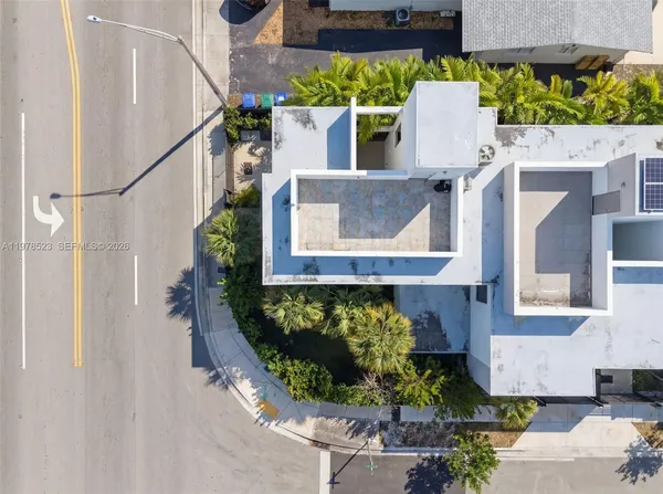 an aerial view of a house with a yard and garden