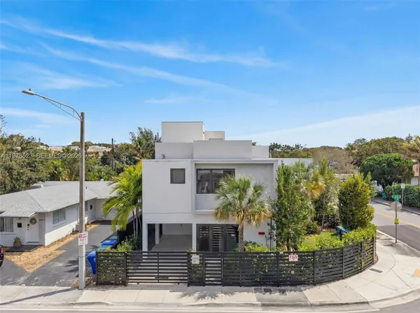 a front view of a house with plants