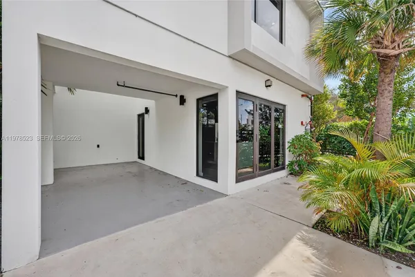 a view of a house with potted plants