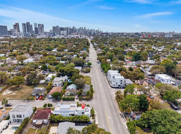 an aerial view of residential houses with city view
